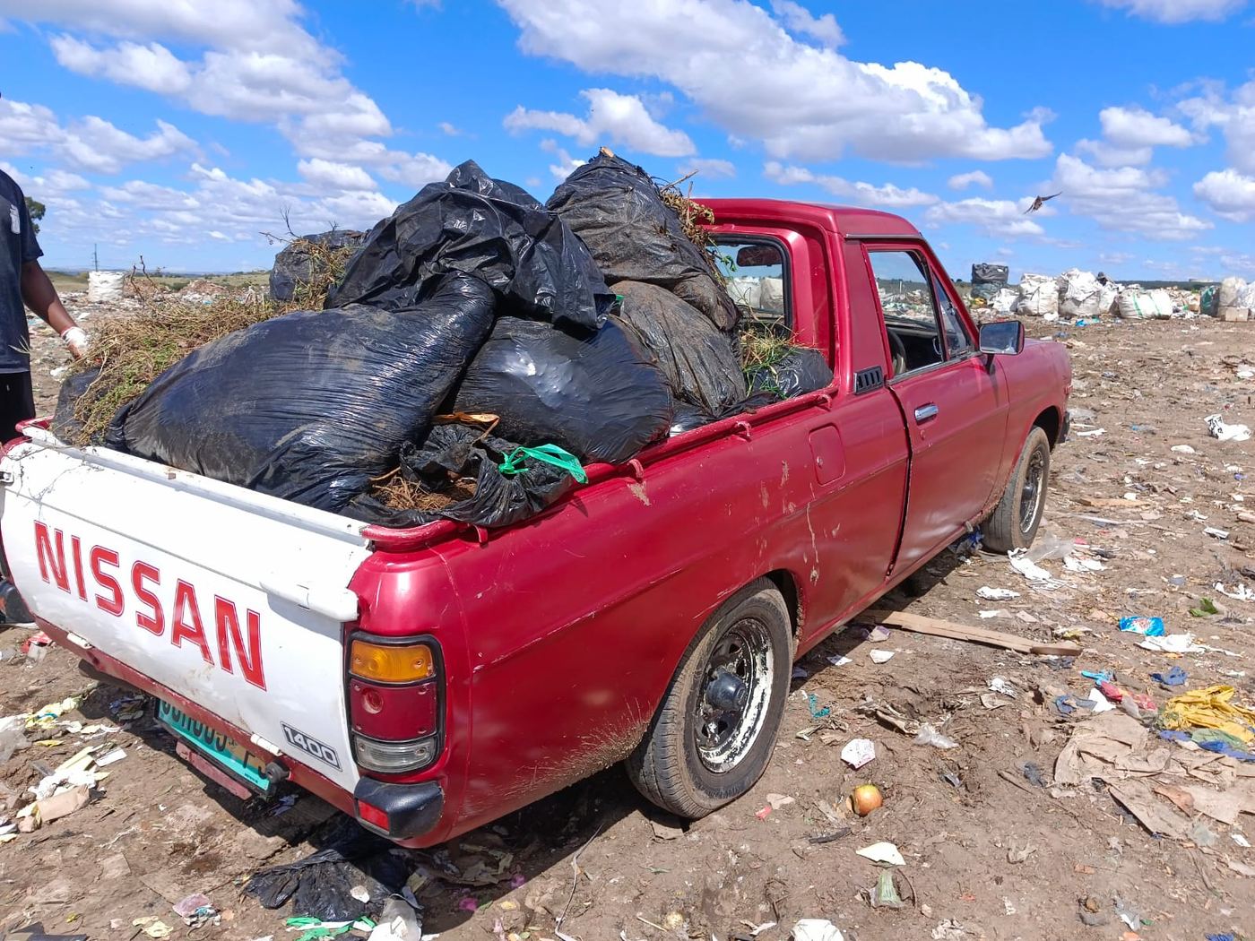 MoveFlex bakkie loaded with bagged waste parked at the municipal landfill site