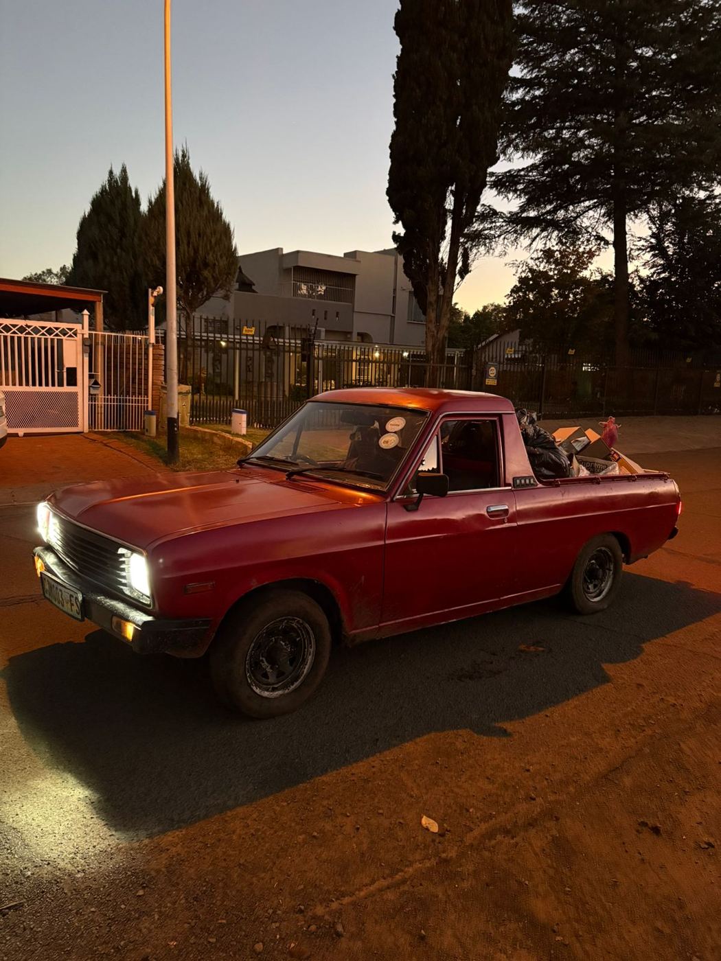 MoveFlex bakkie loaded and heading out on a job at dusk with headlights on